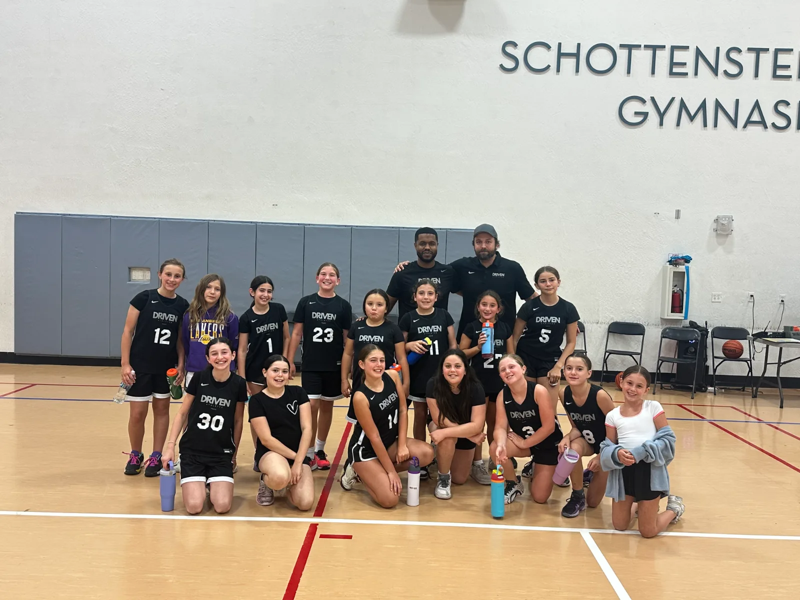 Driven Athletes girls team with their coaches after a game