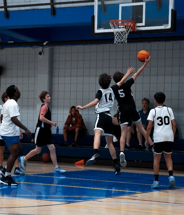 Driven Athletes gameplay at the Michael-Ann Russell JCC — player finishing a layup at the rim
